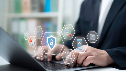Businessman using laptop with virtual data security interface shield icon cloud lock privacy documents firewall alert smart cybersecurity protection system for digital safety