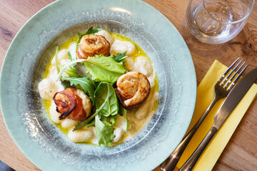 Gnocchi with creamy sauce and bacon-wrapped chicken