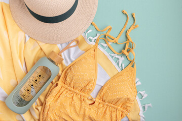 Beach essentials including swimwear, hat, towel, and water bottle.