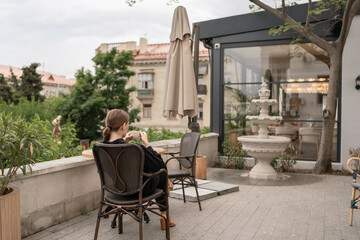 Coffee Woman Patio: Woman drinks outdoors, morning, patio seating, relaxing in casual wear,...