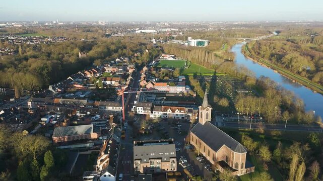 essence melle village&rsquo;s town center church river scheldt surrounding countryside sunshine enhance rural charm belgium circling shot scenic view visual impact 