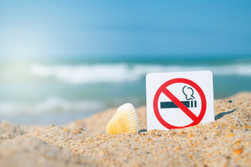 No Smoking sign. Prohibitory sign against the background of sand and sea, ocean. Attention, smoking is prohibited.	