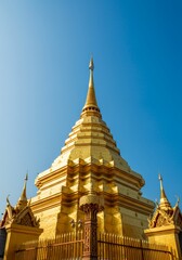 Fototapeta premium Majestic Golden Pagoda under a Clear Blue Sky