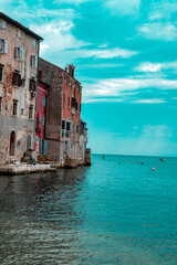 Rustic Waterfront Buildings Reflected on Calm Coastal Waters in Italy