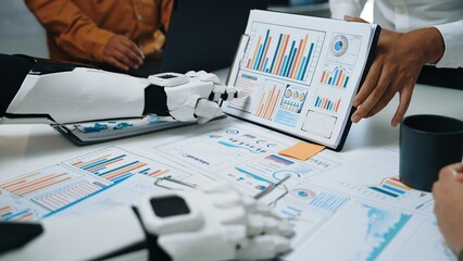 A robot and human engaging in a business meeting, showcasing charts and data analysis on a...