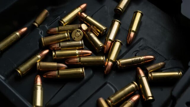 Various spent shell casings are inspected at a shooting range. The video highlights distinct cartridge sizes and their firing mechanisms while emphasizing safety and handling practices