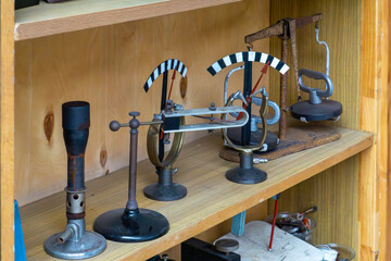 set of vintage educational mechanical models demonstrating centrifugal force and lever mechanisms, displayed on a wooden shelf. Retro style, used in technical schools during the communist era.