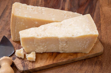 Traditional italian food, 36 months aged in caves Italian parmesan hard cheese from Parmigiano-Reggiano and grana padano from Po river valley, Italy