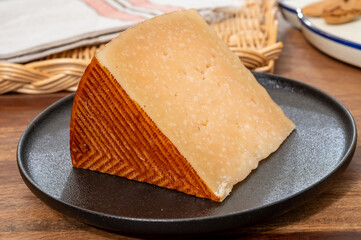 Very old anejo tostado Spanish hard cheese, cow and sheep curado, manchego, goat cheese close up