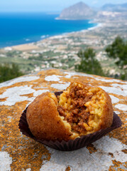 Arancini Sicilian, deep-fried rice balls made with risotto, filled with ingredients mozzarella, ragu, peas, coated in breadcrumbs fried to crispy in Erice, Sicily, Italy