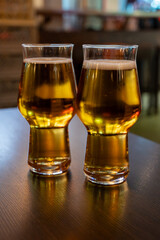 Freshly brewed light pils German beer in craft brewery served in beer glass poured from keg