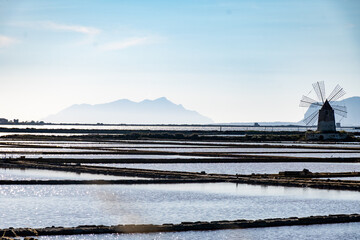Sea saltworks, salt wind mills and pans, manually extracting high-quality salt, near Marsala and...