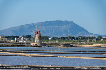 Sea saltworks, salt wind mills and pans, manually extracting high-quality salt, near Marsala and...