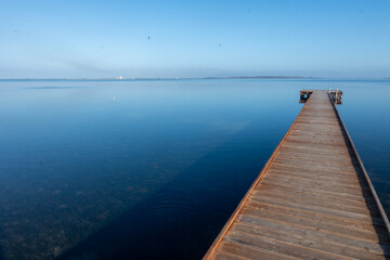 Obraz premium Morning stillness and mirror-quiet water at Stagnone of Marsala, lagoon and nature reserve near Marsala, Sicily, Italy, fisherman's boats