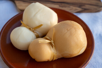 Italian semi hard handmade white and smoked scamorza cheese, from cow milk from Apulia or Calabria...