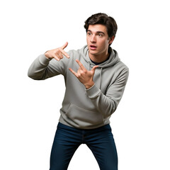 Stock photo of young man in hoodie gesturing with hands isolated on black background for creative use on transparent background