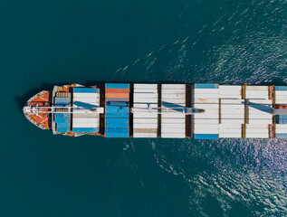 Freight container on cargo vessel. Cargo ship vessel leaving port. Container ship. Export and...