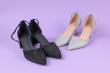 Elegant Black and Silver High Heels on Purple Background: Fashion Footwear Contrast