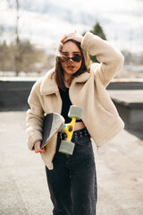 Young Woman with Skateboard in Urban Setting