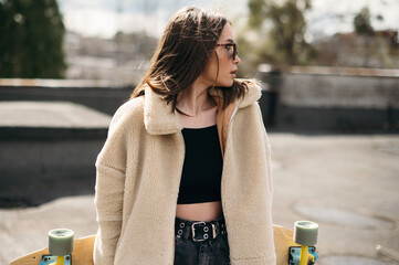 Stylish Young Woman with Skateboard Outdoors