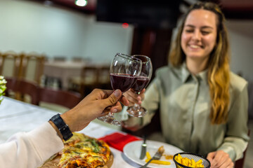 Young Couple Toasting with Red Wine Before Dinner