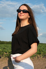 Portrait of young attractive woman in sunglasses against blue sky	