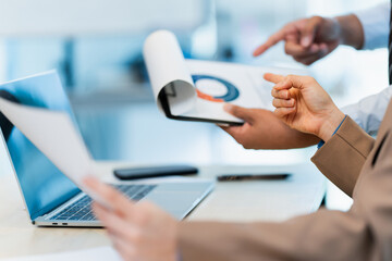 Two colleagues sitting and discussing business strategy in modern workspace