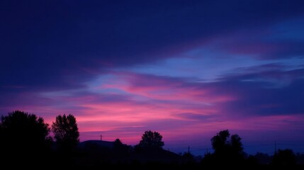Photograph of a beautiful sunset. the sky is filled with vibrant colors, ranging from deep blues and purples to bright oranges and yellows.