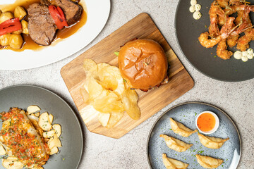 Overhead view of various international dishes served on a table, creating a vibrant and diverse...