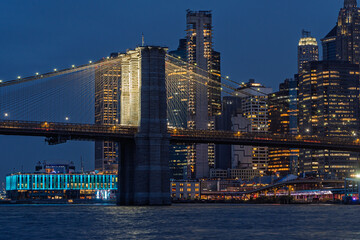 Manhattan Skyline at dusk with the Brooklyn Bridge on a warm evening