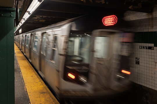 Subway Train Speeds through a Subway Station in a city