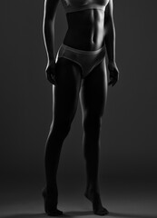 A slender swarthy woman in white underwear on a white cosmetology room. Healthy lifestyle, sport...