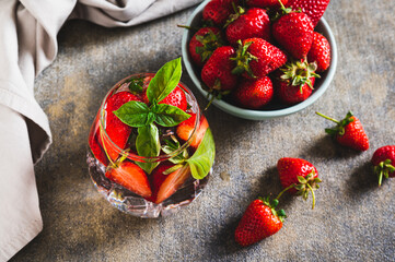 Wellness detox drink with strawberries and basil in glasses on table