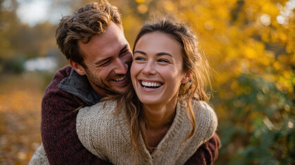 Fototapeta premium Autumn Romance: Couple Laughing Together During a Piggyback Ride