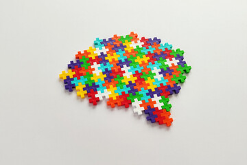 Brain shaped colorful jigsaw puzzle on white background.