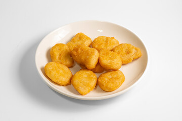 chicken nuggets on white plate