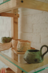 Products made of natural clay. Ceramic tableware store. Workshop for the production of clay products. Handmade mug or candlestick. Handmade clay products. Beautiful cups, mugs or candlesticks. 