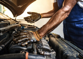dirty hands from engine oil, auto mechanic, working on car engine