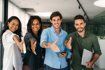 Group of young multi-ethnic startup business team collaborating on project in modern office