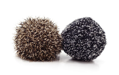 Curled up hedgehog and a ball of yarn. © voren1