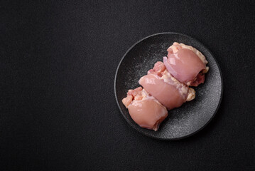 Raw chicken thigh fillet without skin and bone with salt and spices. Raw chicken fillet for cooking