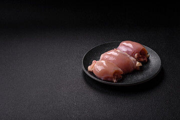 Raw chicken thigh fillet without skin and bone with salt and spices. Raw chicken fillet for cooking