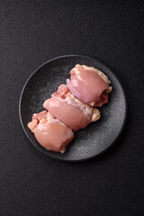 Raw chicken thigh fillet without skin and bone with salt and spices. Raw chicken fillet for cooking
