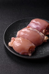 Raw chicken thigh fillet without skin and bone with salt and spices. Raw chicken fillet for cooking