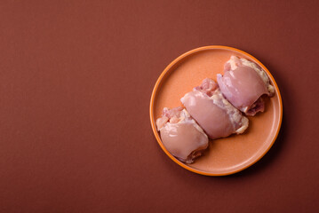 Raw chicken thigh fillet without skin and bone with salt and spices. Raw chicken fillet for cooking
