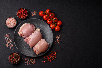 Raw chicken thigh fillet without skin and bone with salt and spices. Raw chicken fillet for cooking