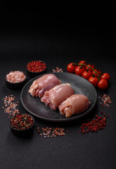 Raw chicken thigh fillet without skin and bone with salt and spices. Raw chicken fillet for cooking