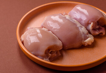 Raw chicken thigh fillet without skin and bone with salt and spices. Raw chicken fillet for cooking