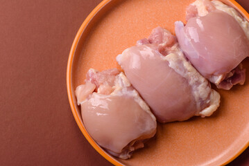 Raw chicken thigh fillet without skin and bone with salt and spices. Raw chicken fillet for cooking