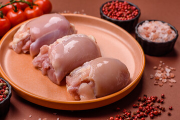 Raw chicken thigh fillet without skin and bone with salt and spices. Raw chicken fillet for cooking
